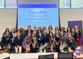 A group of women stand together in front of a screen reading: "FoundHer: Cultivating women academic entrepreneurs."